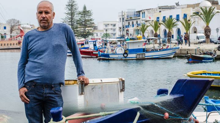 Jamel Mouhalib stands on his boat in the old port of Bizerte. 